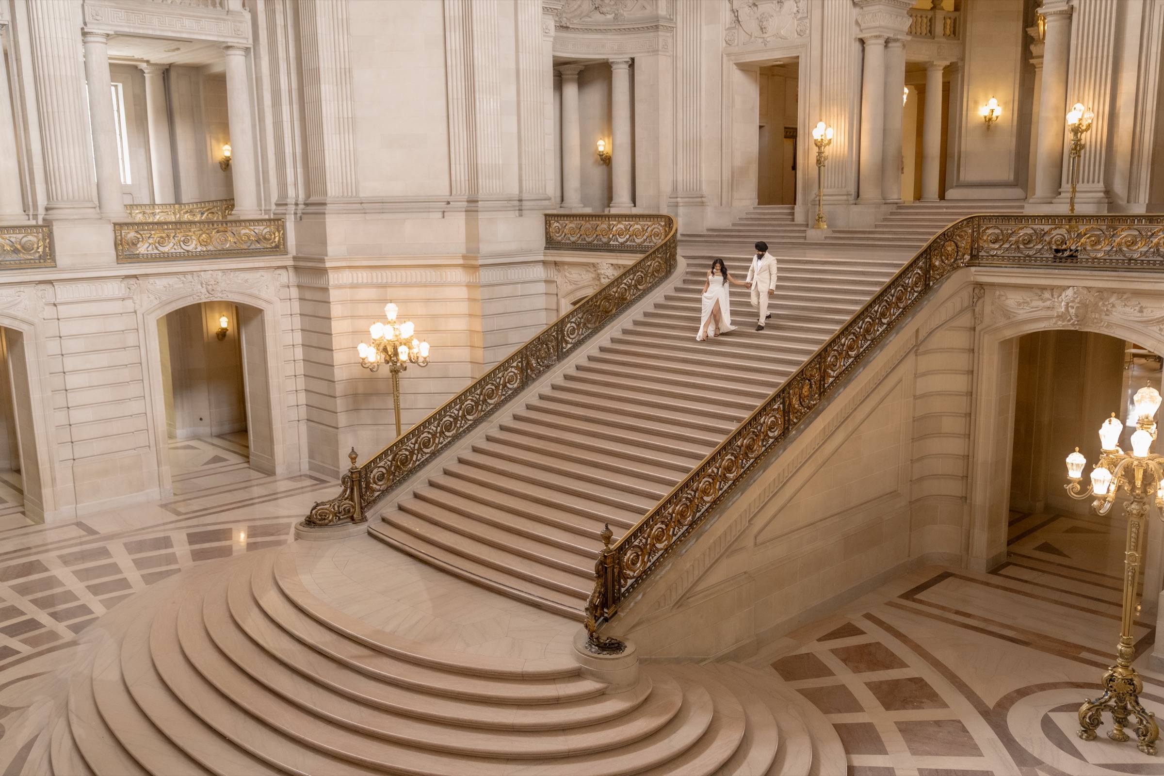Harjinder and Karmjit descending the grand staircase at San Francisco City Hall